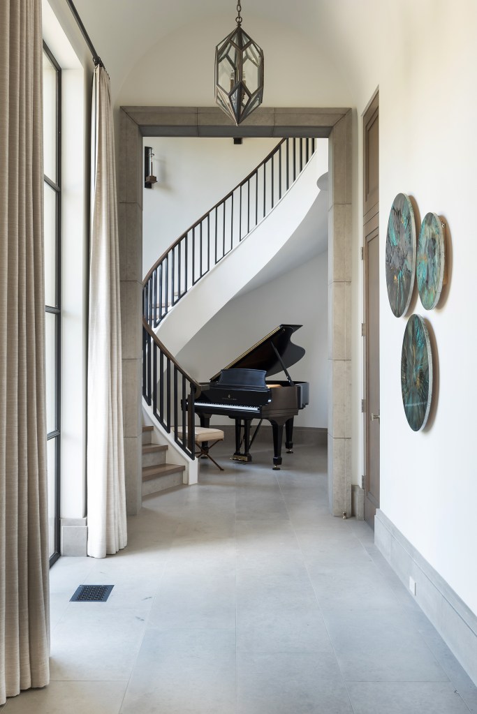 Italian Limestone, Italian Limestone base, Dallas Estate Home, Old Preston Hollow Estate, Luxury Homes Dallas, Brass handrail, circular stair, limestone cased openings, custom limestone cased opening, Iron windows, wet glazed iron windows, limestone stair risers, custom 11' oak doors, water jet limestone baseboard