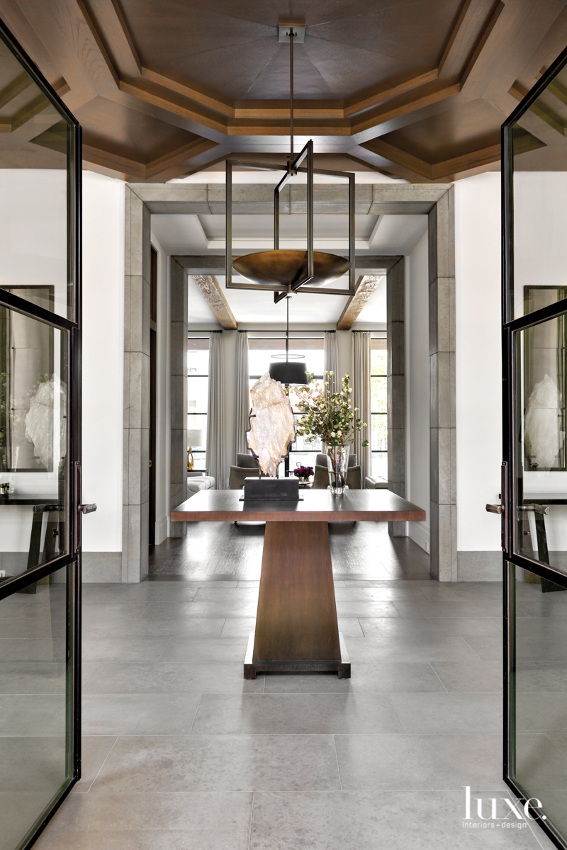 Luxury home entryway with stone floors and custom chandelier