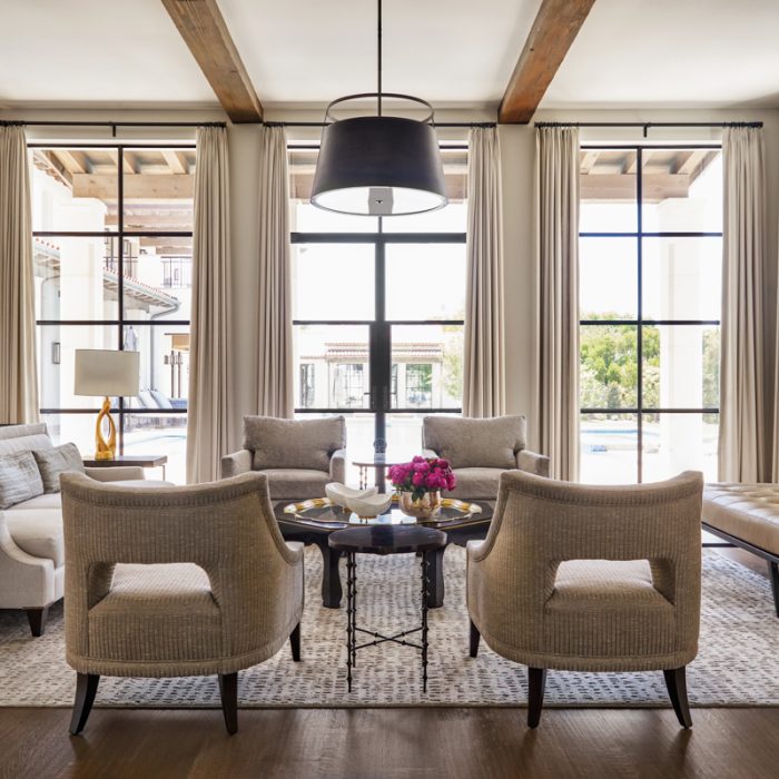 Luxury home living room with floor-to-ceiling windows and pool view